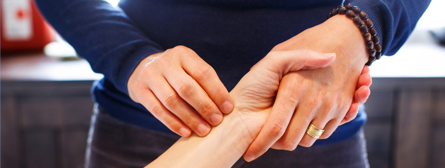 acupuncturist taking pulse